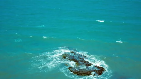 Vintage top down view of turquoise sea waves crashing on a submerged reef rock Stock Footage 341360392