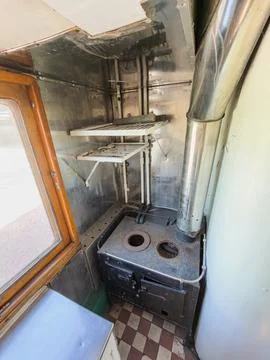 Vintage train car interior, compact kitchenette, functional space, metallic.. Stock Photos