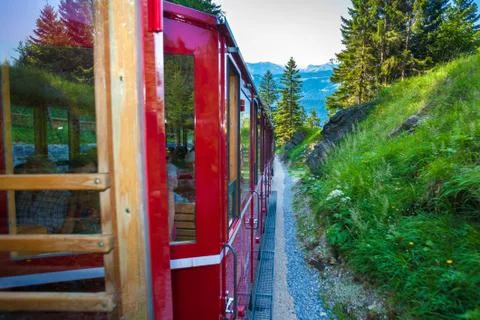 Vintage train eith red carriages cogwheel railway going to schafberg peak Stock Photos