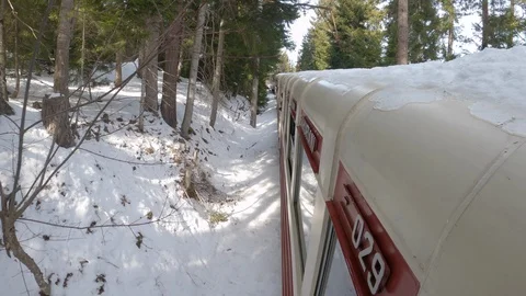 Vintage train rides through winter forest and mountains 库存影片 127413972