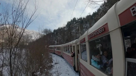 Vintage train rides through winter forest and mountains 库存影片 127415715