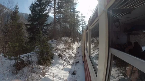Vintage train rides through winter forest and mountains 库存影片 127416184