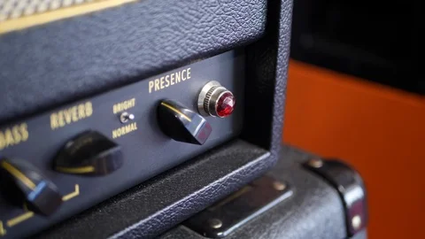 A vintage tube guitar amplifier with knobs and switches in a music studio 動画素材 124228305