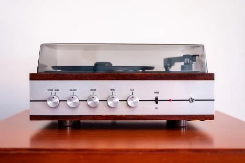 Vintage turntable made of wood and plastic cover on a old table Stock Photos