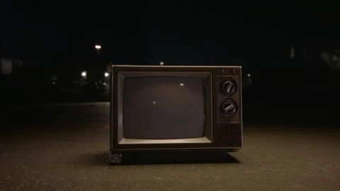 Vintage TV in Middle of Road Turns on Video stock 133530853