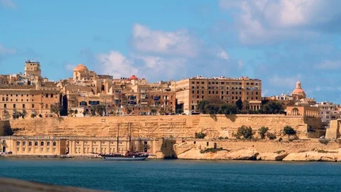 A vintage two mats sailing boat in front of Valletta, Malta Stock Footage 106916928