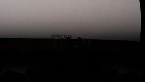 Vintage typewriter printing the word typewriter onto a sheet of white paper Stock Footage 322911603