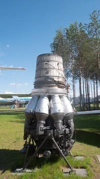 Vintage USSR Rocket Engine on Display in Russia Surrounded by Trees and Aircraft 스톡 사진
