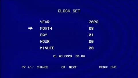 Vintage VCR clock set menu glows on blue CRT screen, showing date and time Stock Footage 346442283