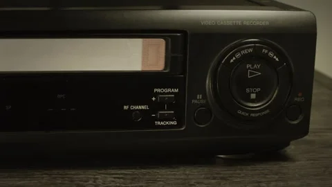Vintage vcr inserting and playing vhs cassette Stock Footage 320138445