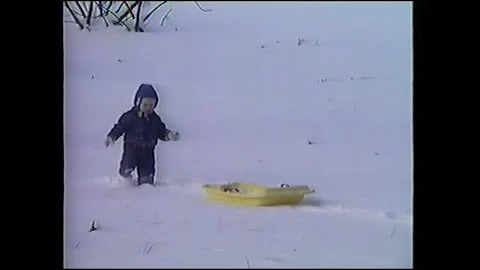 Vintage VHS Child Pulls Sled in Snow Stock-Footage 147052828