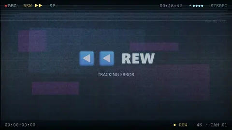 Vintage VHS glitch effect with tracking error and rewind text on a dark blue Stock Footage 345761696