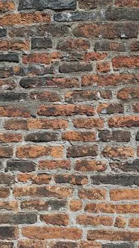 Vintage wall with a background of old bricks of different shades and textures Stock Photos