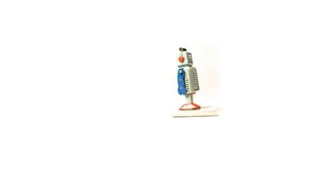 Vintage Wind Up Robot Falling Down From A Stack Of Notes Stock Footage 99575123