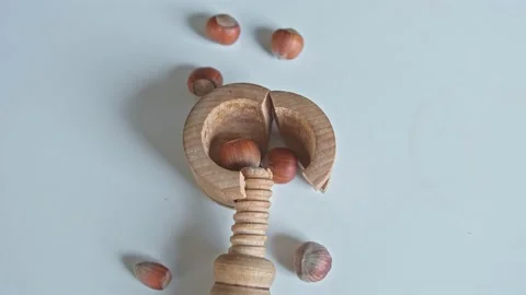 Vintage Wood Screw Nutcracker Broken when Crunching Hard Shell Hazelnuts Stock Footage 228494543