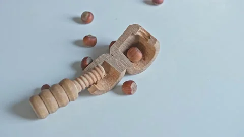 Vintage Wood Screw Nutcracker Broken when Crunching Hard Shell Hazelnuts Stock Footage 228494550