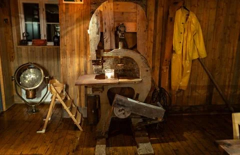 A vintage workshop room with a warm, rustic atmosphere. Wooden walls, old b.. Фото