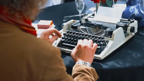 Vintage writer desk style, he is working and typing on his typewriter Stock Footage 70417543