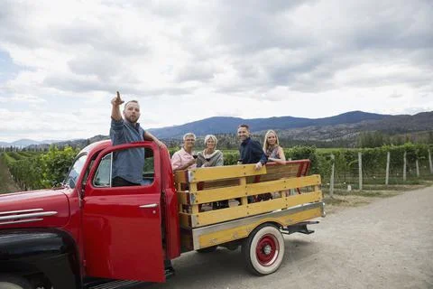 Vintner explaining vineyard to couples wine tasting in truck bed Stock Photos