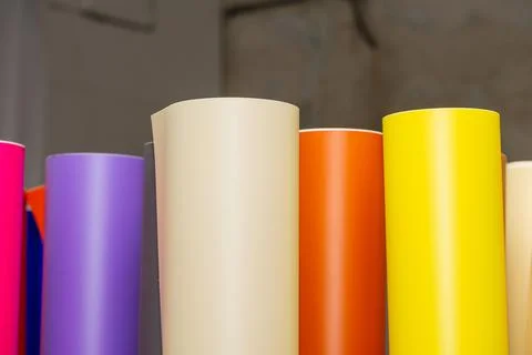 Vinyl car wrapping or plotter cutting sticker foil film rolls. Film colored i Stock Photos