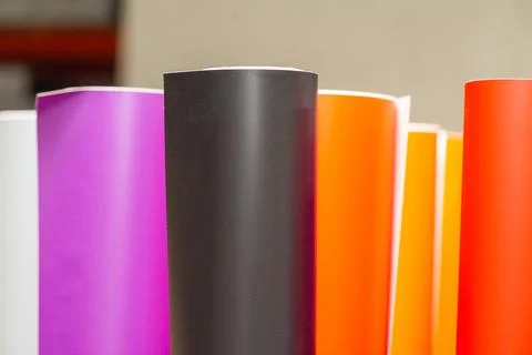 Vinyl car wrapping or plotter cutting sticker foil film rolls. Film colored i Stock Photos