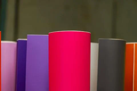 Vinyl car wrapping or plotter cutting sticker foil film rolls. Film colored i Stock Photos