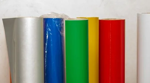 Vinyl car wrapping or plotter cutting sticker foil film rolls. Film colored i Stock Photos