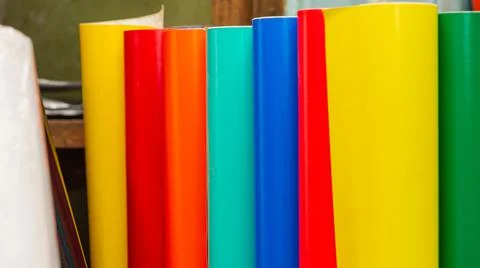 Vinyl car wrapping or plotter cutting sticker foil film rolls. Film colored i Stock Photos