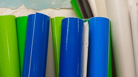 Vinyl car wrapping or plotter cutting sticker foil film rolls. Film colored i Stock Photos