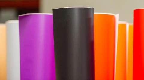 Vinyl car wrapping or plotter cutting sticker foil film rolls. Film colored i Stock Photos