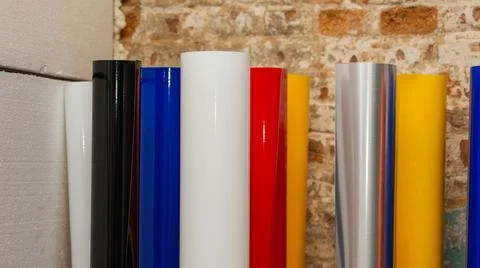 Vinyl car wrapping or plotter cutting sticker foil film rolls. Film colored i Stock Photos