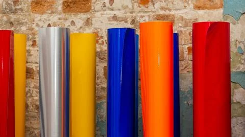Vinyl car wrapping or plotter cutting sticker foil film rolls. Film colored i Stock Photos