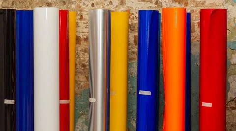 Vinyl car wrapping or plotter cutting sticker foil film rolls. Film colored i Stock Photos