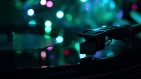 Vinyl disc running on turntable record player. Neon noir cold light background. Stock Footage 96382622