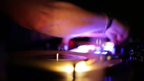 Vinyl dj arm in action - rotating disc in a club - Dj playing music at mixer Stock Footage 84887964