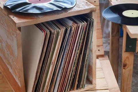 Vinyl record with copy space in front of a collection albums dummy titles Stock Photos