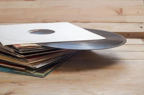 Vinyl record with copy space in front of a collection of albums dummy titles Stock Photos