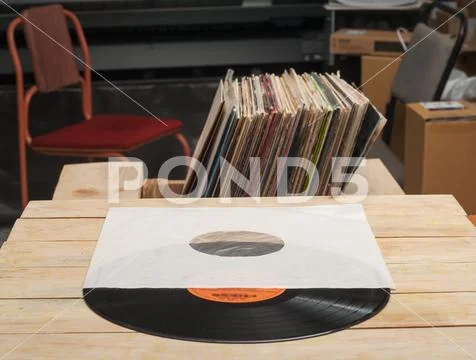 Vinyl record with copy space in front of a collection of albums dummy titles Stock Photos