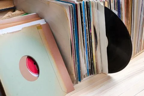 Vinyl record with copy space in front of a collection of albums dummy titles Stock Photos