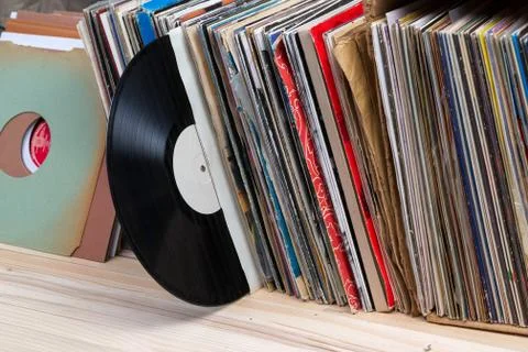 Vinyl record with copy space in front of a collection of albums dummy titles Stock Photos