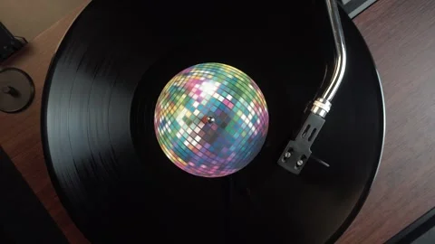 Vinyl Record With Disco Ball Sticker Playing on Turntable, Top Down View Stock Footage 334780489