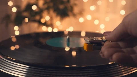 The vinyl record on DJ turntable record player. The girl's hand puts stylus Stock Footage 91683998