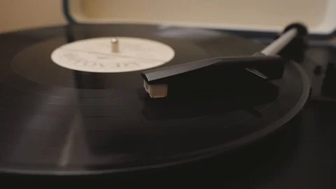 A vinyl record is played in the player Stock-Footage 124113913