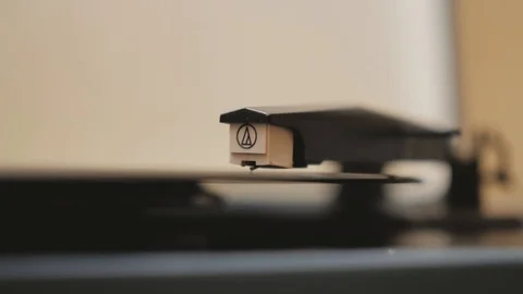 A vinyl record is played in the player Stock Footage 125806851