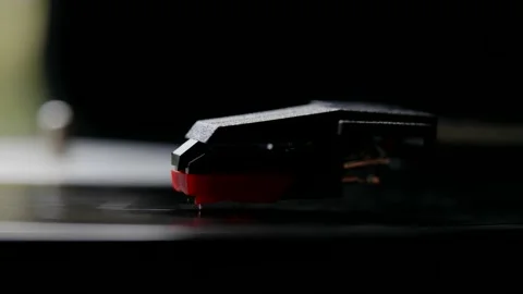 A vinyl record player. Close-up of a rotating vinyl record and a pickup needle Stock-Footage 164035364