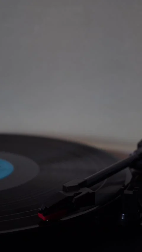 Vinyl record player needle dropping on spinning record in vertical format Stock Footage 333980999