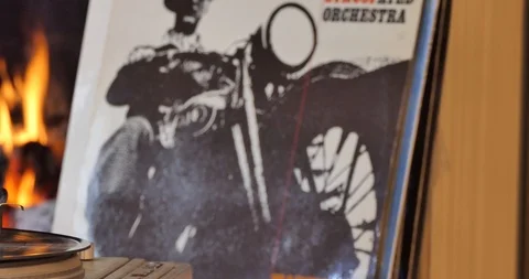 Vinyl record player with a record on the background of the fireplace. Video stock 110691993