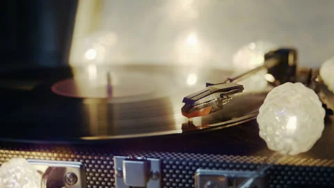 Vinyl Record Playing During a Relaxing Evening with Warm Lights Stock Footage 345398680