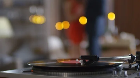 Vinyl Record Playing on Turntable and Unrecognizable Couple Dancing Stock Footage 114051872