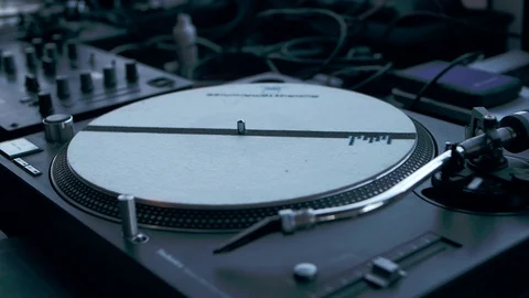 Vinyl record rotates on a DJ setup close-up Stock Footage 89498776